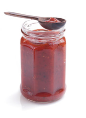 tomato sauce in glass jar on white