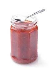tomato sauce in glass jar on white