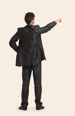 Full length of business man pointing at copyspace
