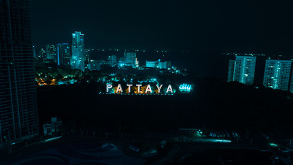 Aerial drone view of colorful Pattaya City sign at night