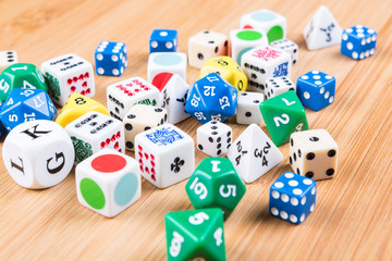 Assorted dice game pieces on a wood background