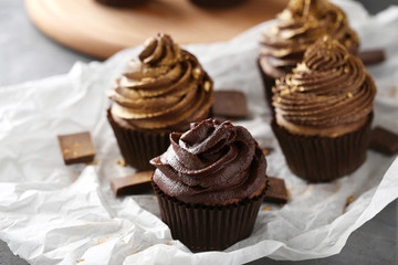 Tasty cupcakes with pieces of chocolate