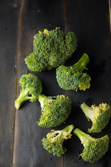 Broccoli on black wooden background