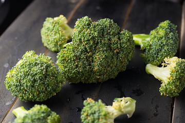 Broccoli on black wooden background