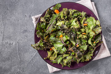 Kale salad on grey background top view with copy space