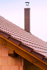 new house with orange brick wall, roof and chimney. House building worker concept.