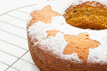 homemade traditional fruit cake on metal stand isolated at white background