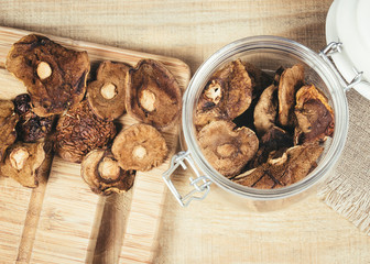 Dried forest mushrooms on a wooden table.