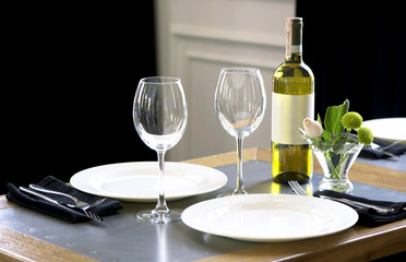 the table in the restaurant is served with white dishes