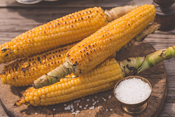 Grilled corn in vintage tray with salt outdoor