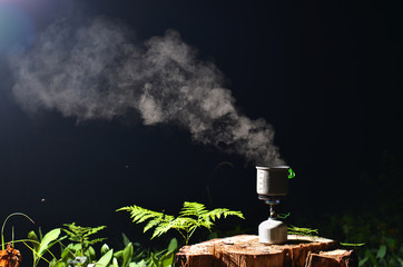 cooking on gas stove in night forest