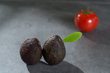 Ripe avocados close up on gray concrete background, healthy food concept, copy space