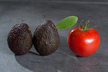 Ripe avocados close up on gray concrete background, healthy food concept, copy space