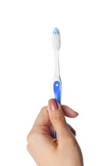 Woman hand holding a toothbrush isolated on white