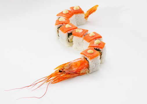 rolls in the form of a dragon with a head of shrimp on a white background