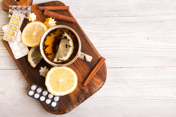 Herbal tea with lemon and pills . Healthcare Concept