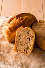 Brick bread in forms on a wooden table.