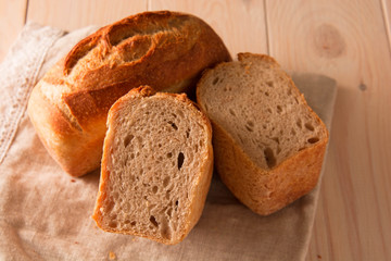 Brick bread in forms on a wooden table.
