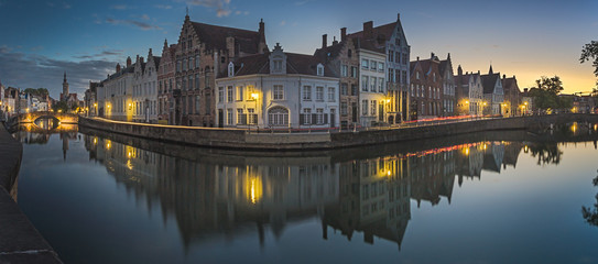 Fototapeta na wymiar Canals of Bruges with the church of our lady in the background, Bruges, Belgium