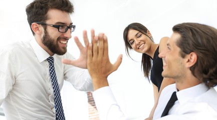 business colleagues giving each other high five.