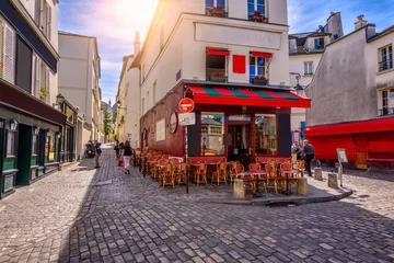 Foto auf Leinwand Cozy street with tables of cafe in quarter Montmartre in Paris, France © Ekaterina Belova