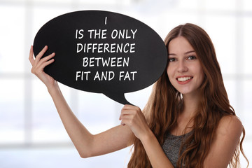 Young beautiful woman holding Speech Bubble with message I is the only difference between fit and fat. Female dieting and Fitness motivation