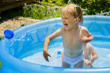 Children swim in the inflatable pool