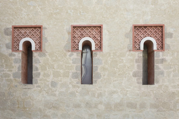 Three front glass small windows of an old medieval house