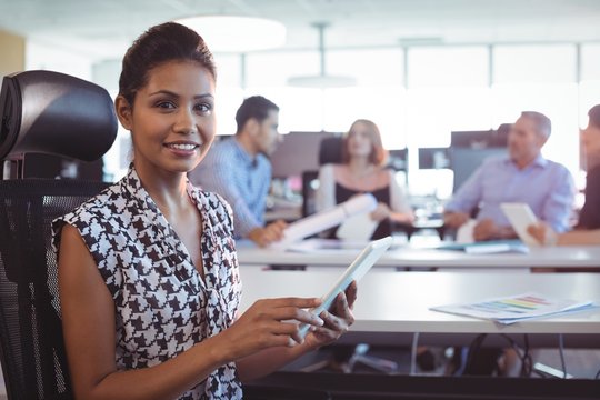 Portrait of businesswoman using digital tablet in office