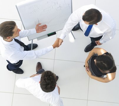 view from the top.the handshake of colleagues before the presentation