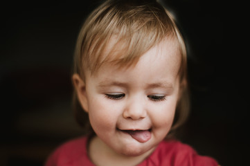 Portrait of toddler sticking her tongue out  © stefanie
