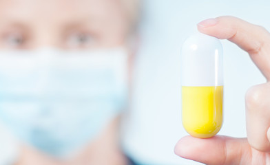 Female doctor, nurse holding a pill