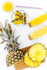Preparing pineapple juice. Cut slices of pineapple. White background top view