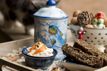 a dinner of cheese with salmon. black bread, homemade cakes. food on a tray. nuts in a cup