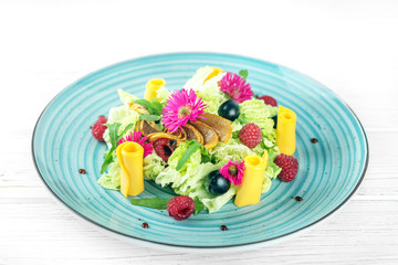 Vegetable salad in a blue plate. The concept is healthy food, diet, vegetarianism.