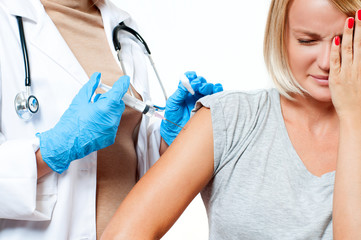 Vaccination. Doctor with syringe making vaccination to patient