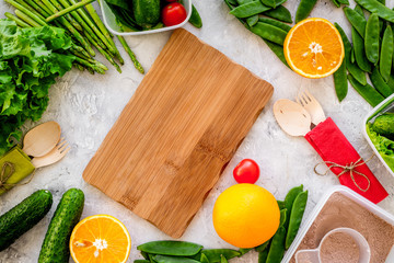Mockup with healthy meal. Vegetables tomato, cucumber, asparagus, salad, pea on grey background top view