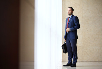 Fototapeta premium Portrait of an handsome businessman in an urban setting.