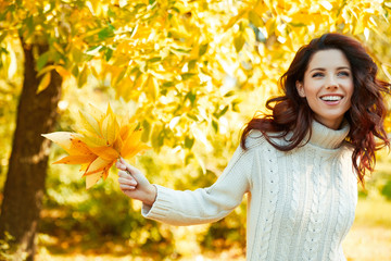 Autumn woman in autumn park. Warm sunny weather. Fall concept