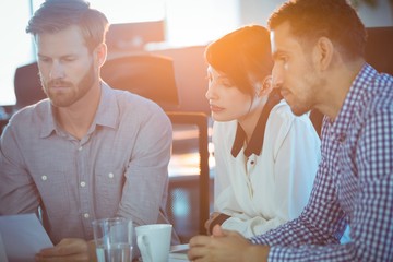 Focused business partners sitting in meeting