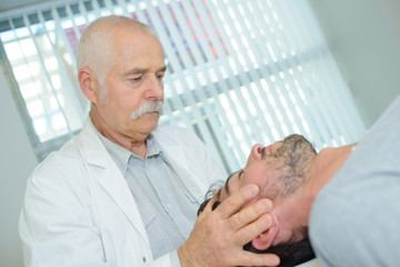 Obraz na płótnie Canvas Chiropractor holding patient's head