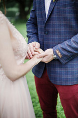 Groom and brides hands closeup view