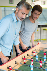 friends playing soccer table football