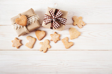 Christmas decoration with gingerbreads and gift boxes.Wooden background.Holiday,new year  concept.Top view.
