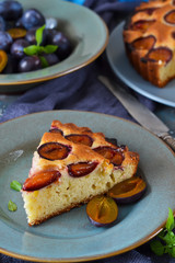 Homemade pie with plums on a concrete background