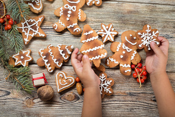 Baby hands holding a Christmas cookie