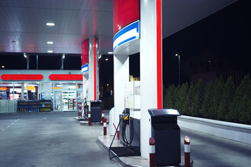 gas station at night, fuel dispensers in focus