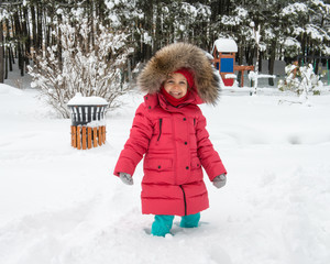 cute girl is playing with snow