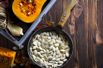 pumpkin seeds grain harvest vitamins vegetables wooden background

