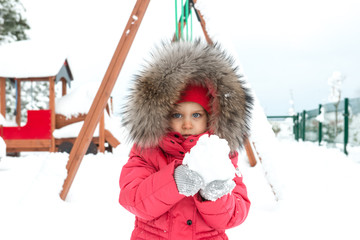 cute girl is playing with snow